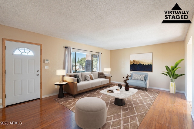 living room with a textured ceiling and hardwood / wood-style flooring