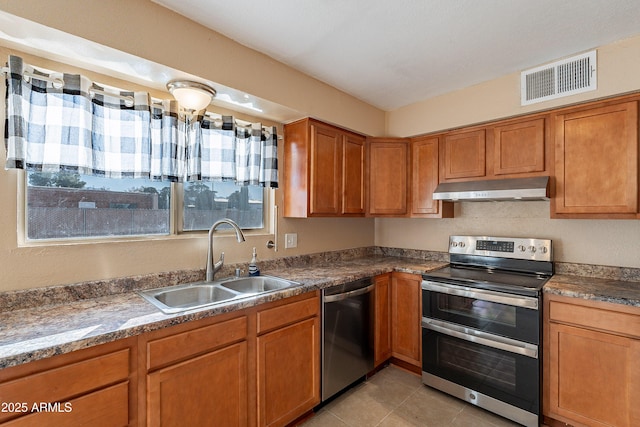 kitchen featuring a healthy amount of sunlight, sink, light tile patterned floors, and stainless steel appliances