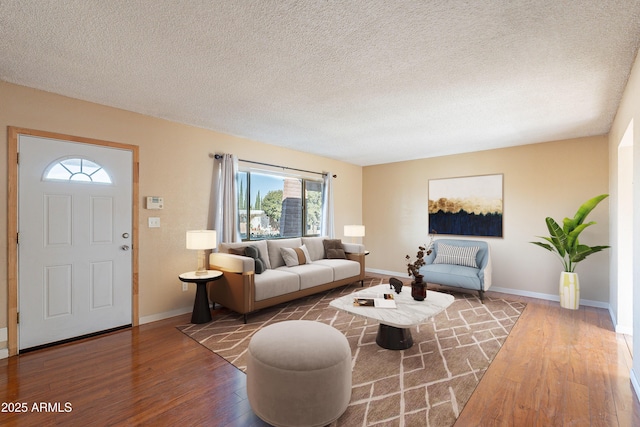 living room with a textured ceiling and hardwood / wood-style flooring