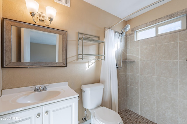 bathroom with a shower with shower curtain, vanity, and toilet