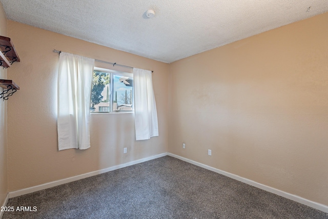 empty room with carpet flooring and a textured ceiling