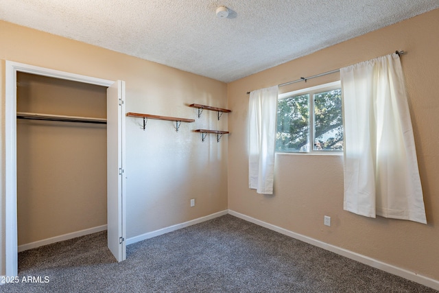 unfurnished bedroom with carpet flooring, a closet, and a textured ceiling