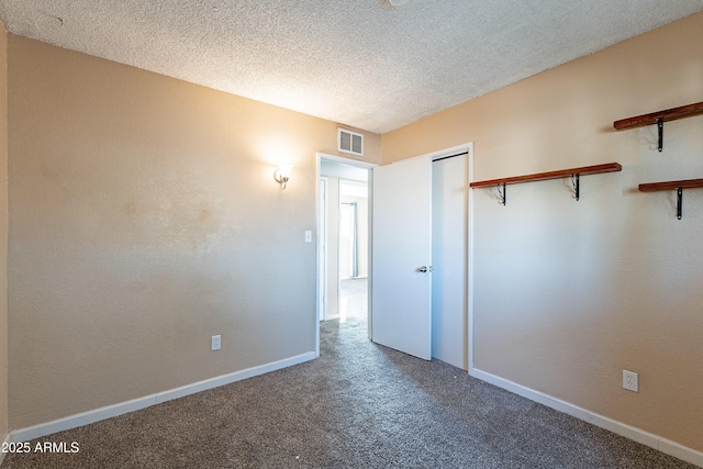 unfurnished bedroom with a closet, carpet floors, and a textured ceiling