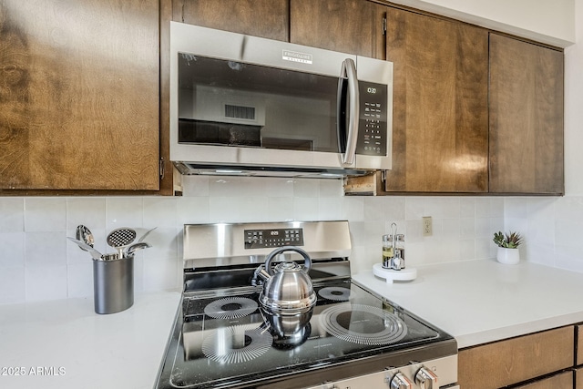 kitchen featuring appliances with stainless steel finishes and decorative backsplash