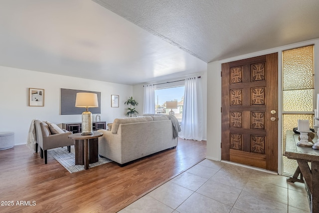 living room featuring light hardwood / wood-style floors and a textured ceiling