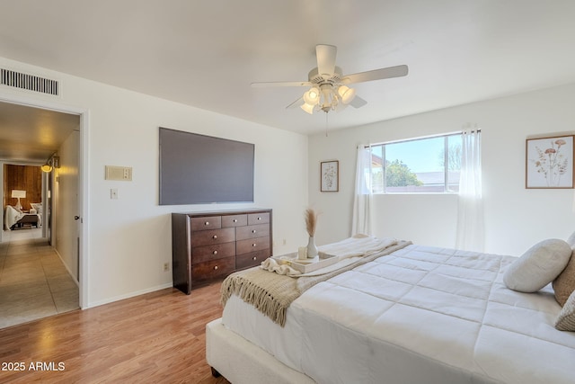 bedroom with ceiling fan and light wood-type flooring