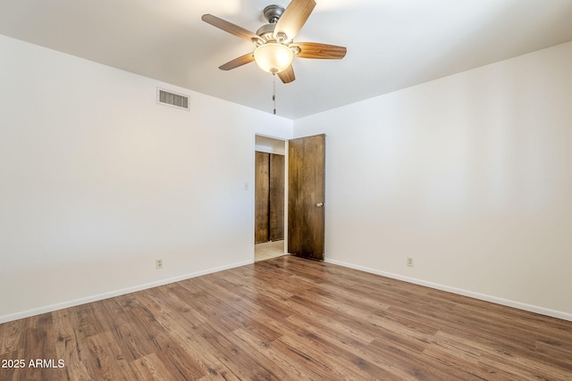 spare room featuring hardwood / wood-style flooring and ceiling fan