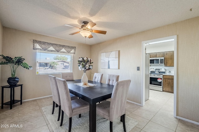 dining room with a textured ceiling, ceiling fan, and light tile patterned flooring