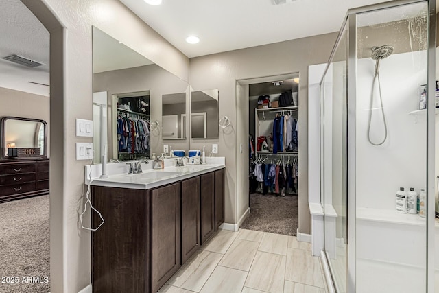 1723 N Hillcrest, Mesa, AZ 85201 - bathroom with double vanity, a walk in closet, and a stall shower