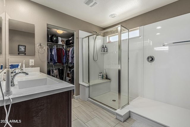 1723 N Hillcrest, Mesa, AZ 85201 - bathroom featuring a stall shower, a walk in closet, and double vanity