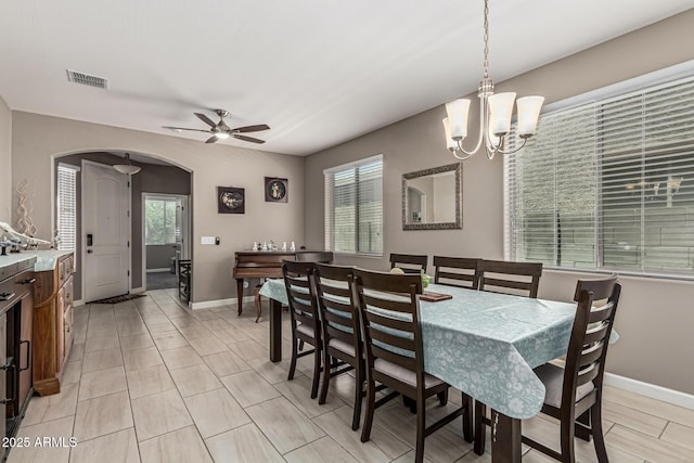1723 N Hillcrest, Mesa, AZ 85201 - dining room with arched walkways, a chandelier, a ceiling fan, and light tile patterned floors