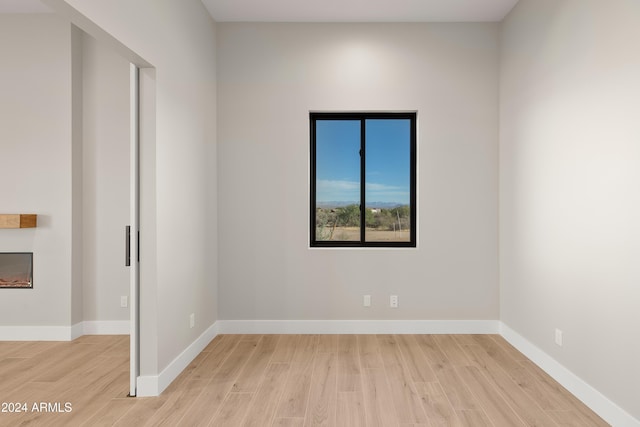 unfurnished room with light hardwood / wood-style flooring