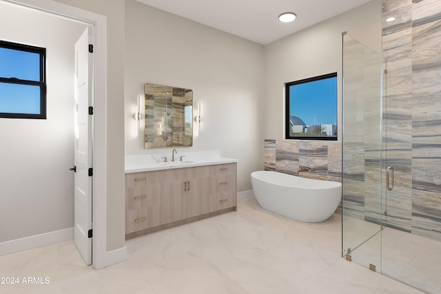 bathroom featuring vanity, plus walk in shower, and a wealth of natural light