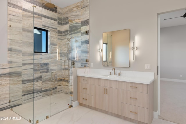 bathroom featuring vanity, ceiling fan, and an enclosed shower