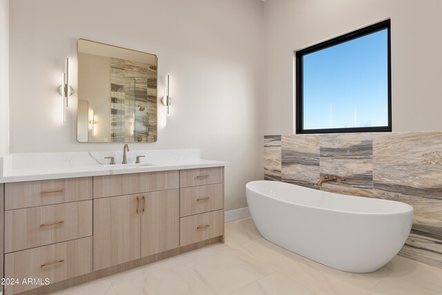 bathroom with vanity, tile walls, and separate shower and tub