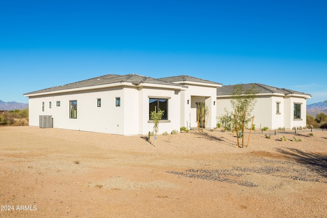 view of front of house with a mountain view and central AC