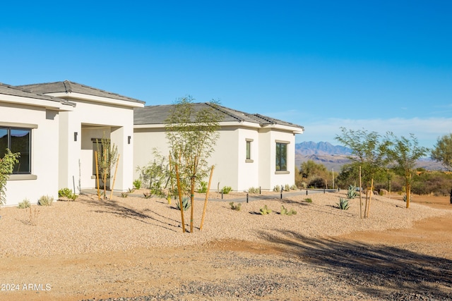 back of property featuring a mountain view