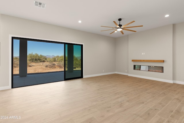 unfurnished living room featuring light hardwood / wood-style floors and ceiling fan