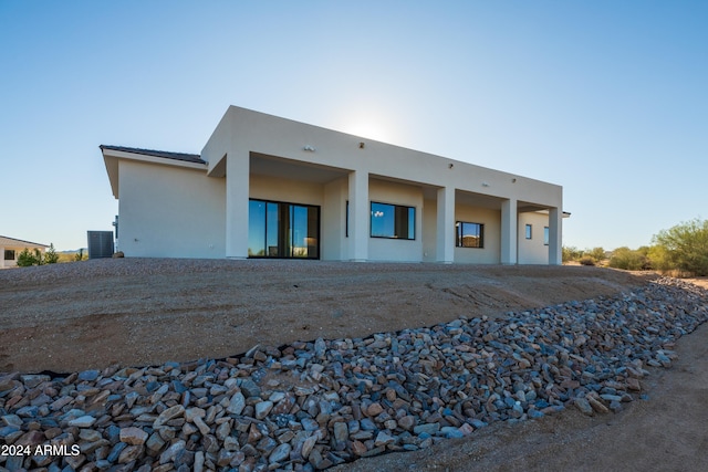 rear view of property with central air condition unit