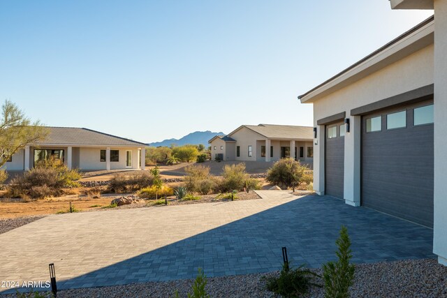 view of yard with a mountain view and a garage