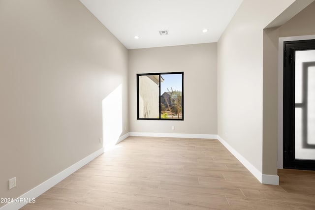 spare room with light hardwood / wood-style flooring