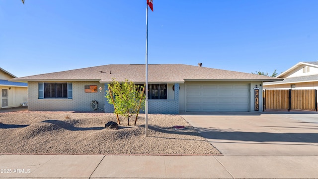 single story home with a garage, driveway, brick siding, and fence