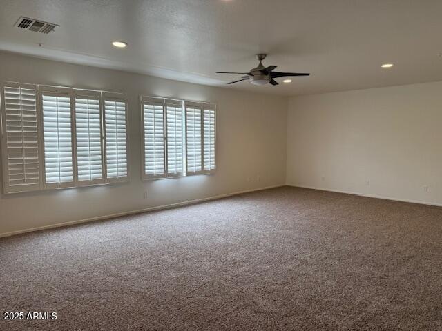 carpeted spare room with baseboards, visible vents, a ceiling fan, and recessed lighting