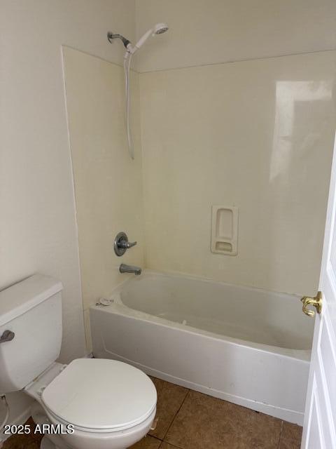 bathroom featuring toilet, shower / bath combination, and tile patterned floors