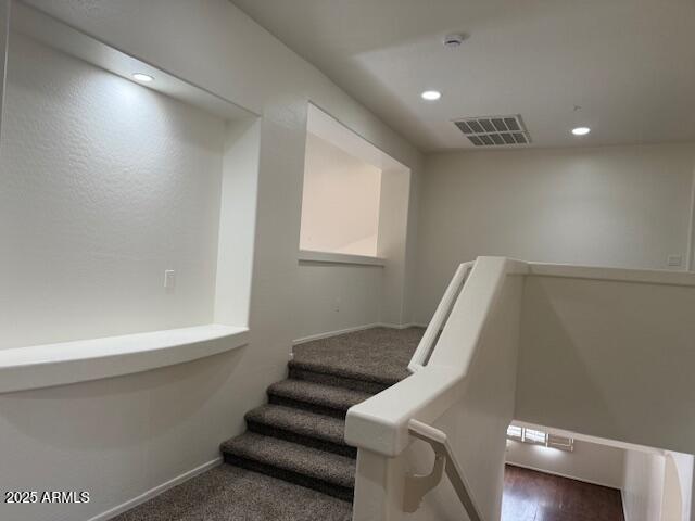 stairs featuring recessed lighting, visible vents, and baseboards