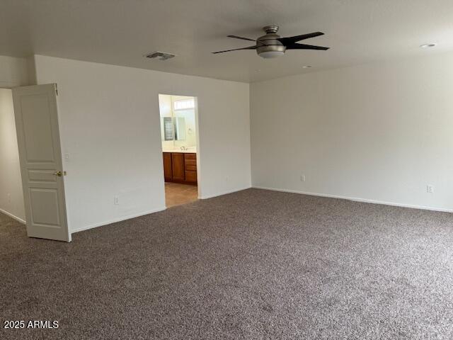 unfurnished room with ceiling fan, baseboards, light carpet, and visible vents