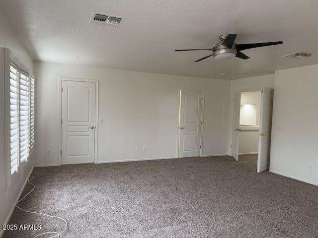 spare room with visible vents, ceiling fan, and plenty of natural light