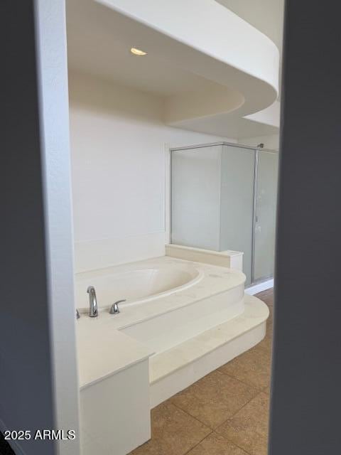 full bathroom featuring a bath and tile patterned floors