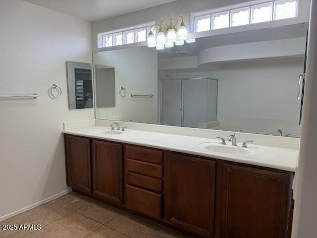 full bathroom featuring double vanity, a sink, tile patterned floors, and baseboards