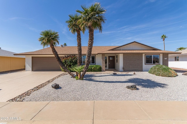 ranch-style house with a garage, brick siding, and driveway