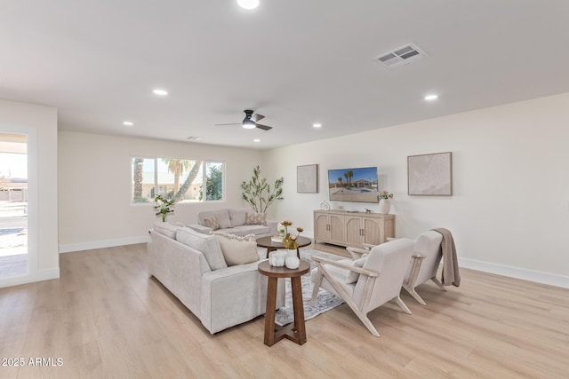 living area featuring baseboards, visible vents, ceiling fan, light wood-style floors, and recessed lighting