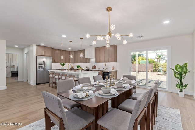 dining room with light wood-style flooring, visible vents, a chandelier, and recessed lighting