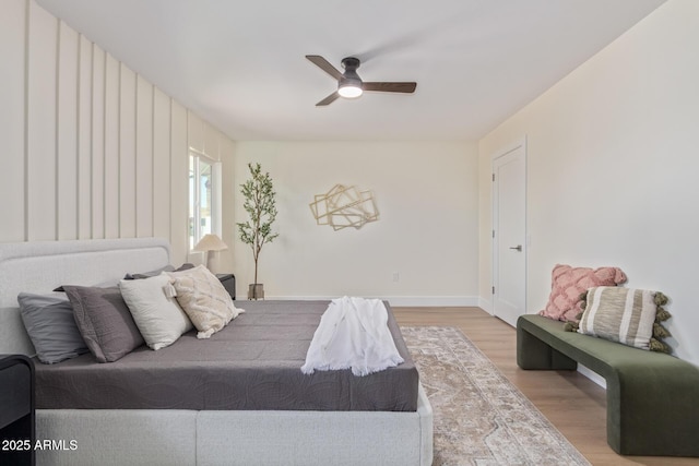 bedroom featuring ceiling fan, wood finished floors, and baseboards