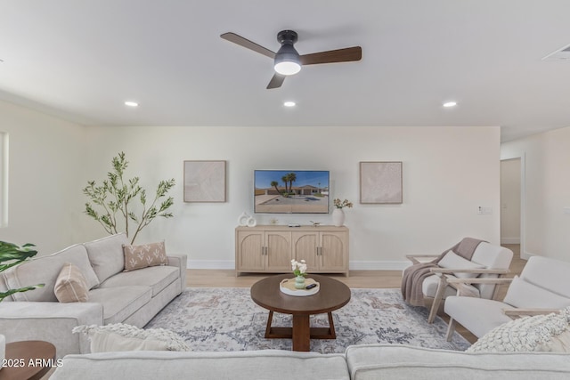 living room with ceiling fan, recessed lighting, baseboards, and light wood-style floors