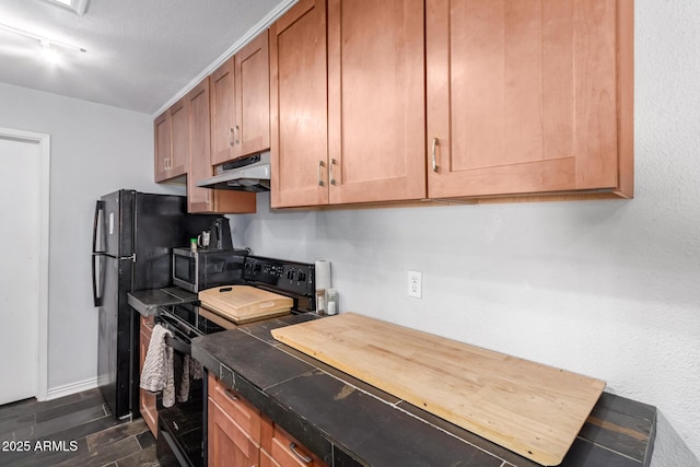 kitchen with rail lighting, black appliances, and a textured ceiling