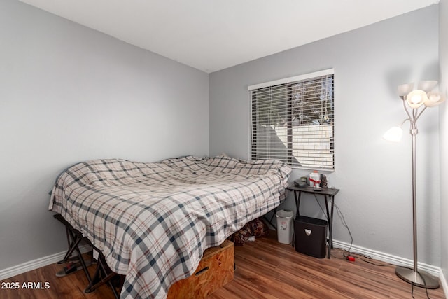 bedroom with hardwood / wood-style floors