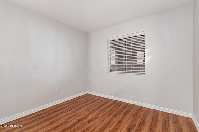 unfurnished room with hardwood / wood-style floors