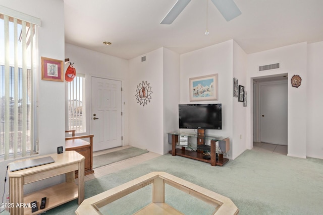 living room featuring light carpet and ceiling fan