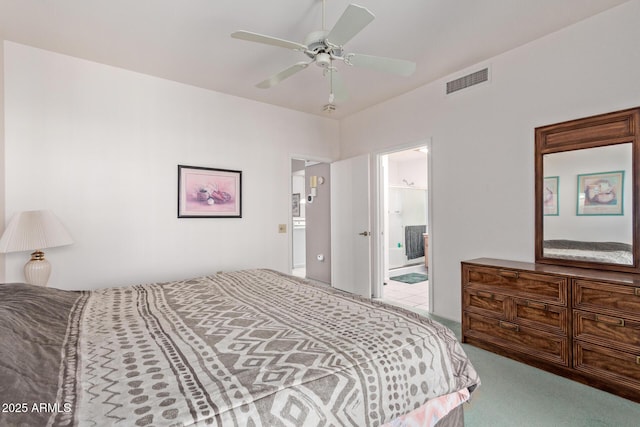 bedroom with ceiling fan, connected bathroom, and light carpet