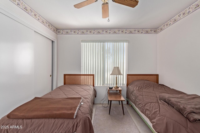 bedroom featuring ceiling fan, carpet floors, and a closet