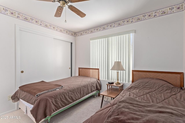 bedroom featuring a closet, ceiling fan, and light tile patterned flooring