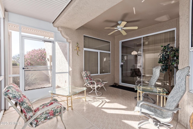 sunroom featuring ceiling fan