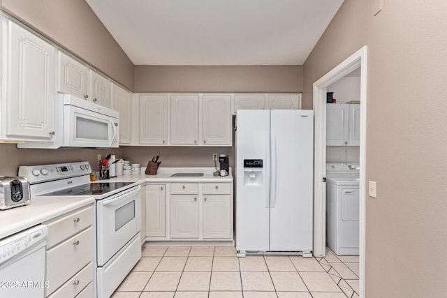 kitchen with white cabinetry, light tile patterned floors, white appliances, and washer / dryer