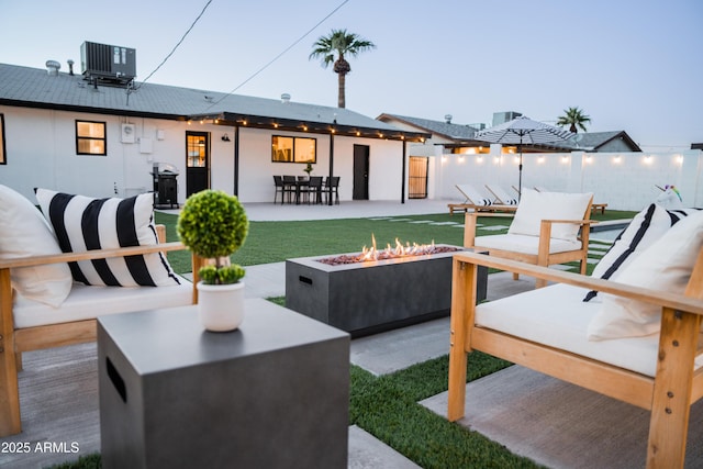 view of patio / terrace with cooling unit and an outdoor living space with a fire pit