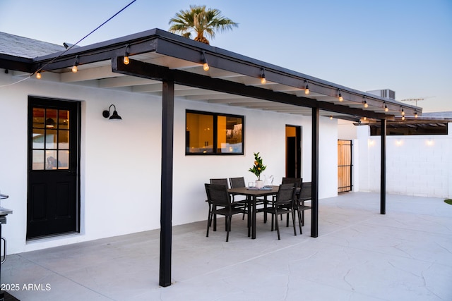 view of patio featuring outdoor dining space and fence