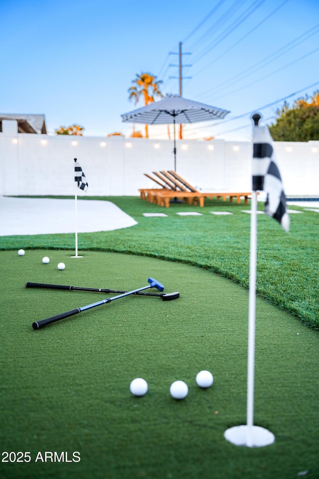 surrounding community featuring an area to practice putting
